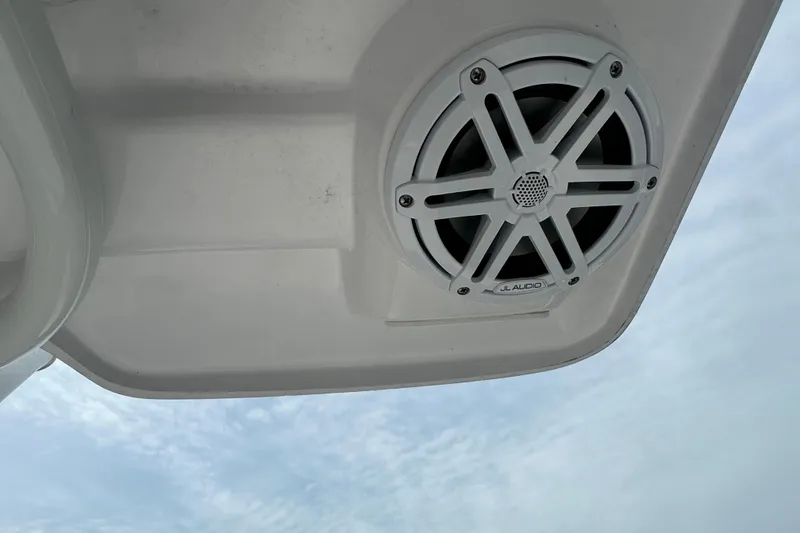 Slide: The Image of 2024 Aquasport 230 Pro Bay boat speaker against a cloudy sky. - 10