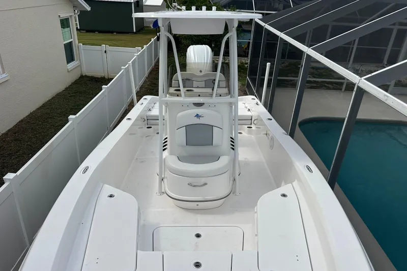 Slide: The Image of 2024 Aquasport 230 Pro Bay boat with spacious deck and modern design. - 13