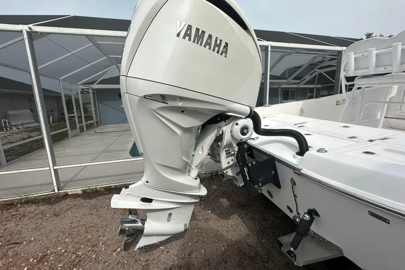 Slide: The Image of 2024 Aquasport 230 Pro Bay boat with Yamaha outboard motor, displayed outdoors. - 5