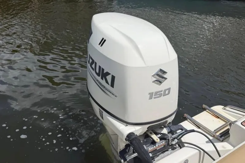 Slide: The Image of Suzuki 150 outboard motor on 2018 Pioneer 202 Islander boat in water. - 2