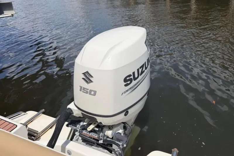 Slide: The Image of Outboard motor on 2018 Pioneer 202 Islander boat, Suzuki 150 horsepower, on water. - 3