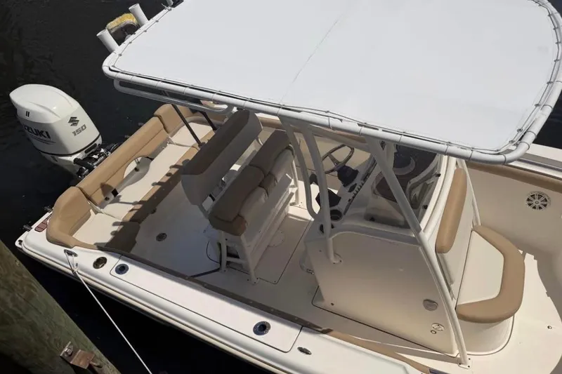 Slide: The Image of 2018 Pioneer 202 Islander boat with Suzuki 150 engine, featuring spacious seating and T-top. - 6