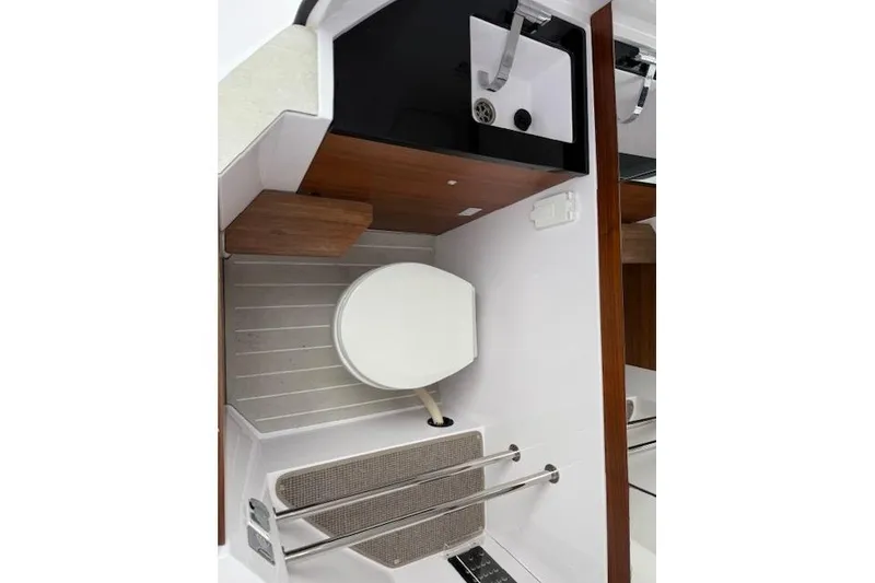 Slide: The Image of Interior of 2022 Axopar 28 Cabin with toilet and sink. - 11
