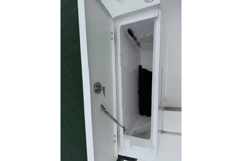 Slide: The Image of Open storage compartment on 2022 Axopar 28 Cabin boat, showing interior details. - 14