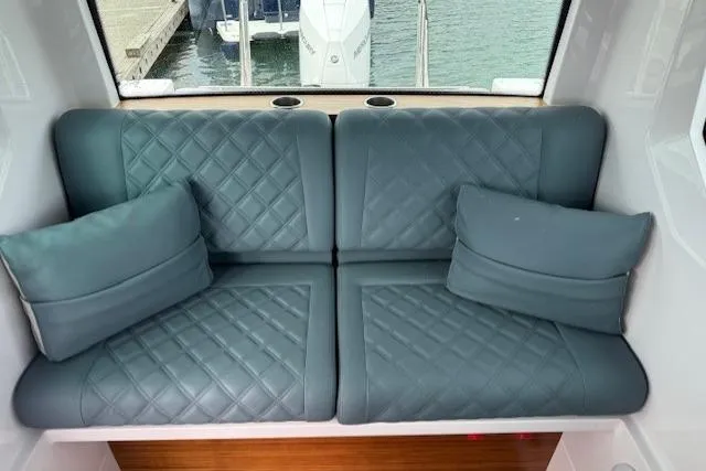 Slide: The Image of Luxurious seating inside 2022 Axopar 28 Cabin boat with quilted cushions. - 8