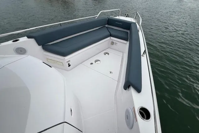 Slide: The Image of 2022 Axopar 28 Cabin boat with sleek seating on calm water. - 9