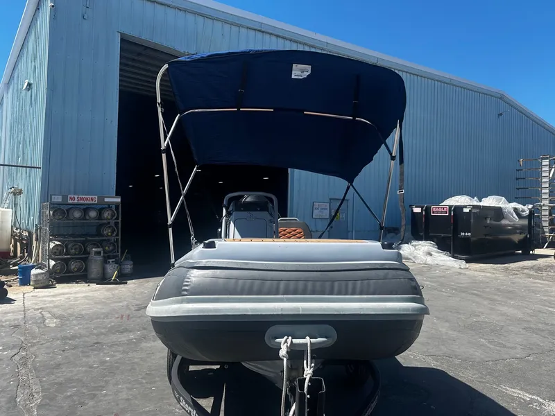 Slide: The Image of 2021 Highfield Sport 360 boat with canopy in industrial setting. - 3