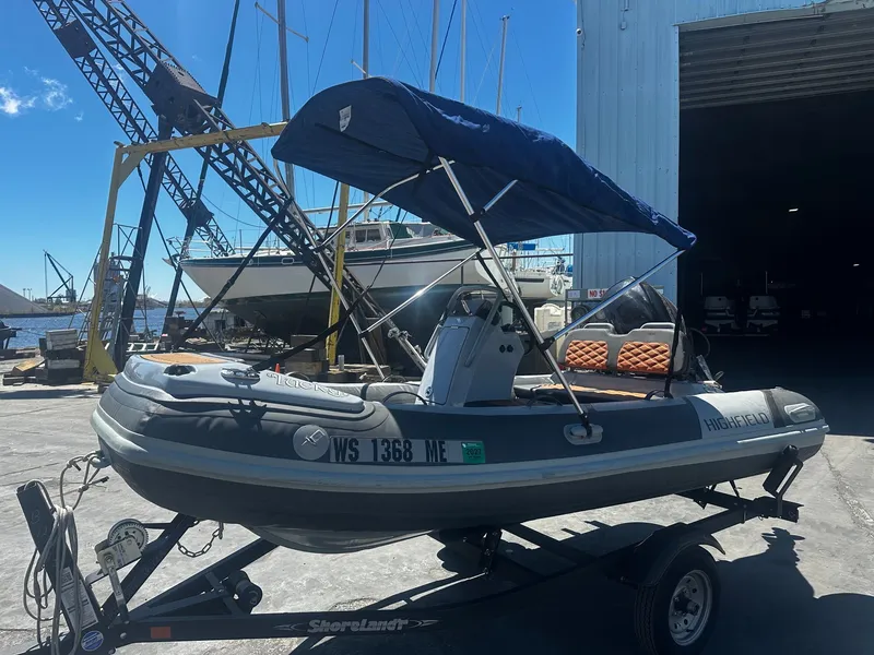 Slide: The Image of 2021 Highfield Sport 360 inflatable boat on trailer at harbor. - 4