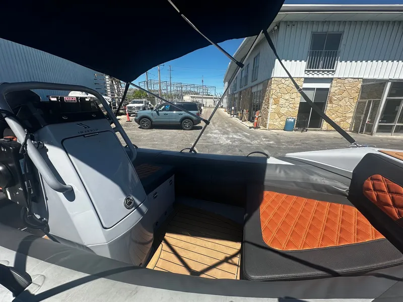 Slide: The Image of Interior of a 2021 Highfield Sport 360 boat with orange seating. - 8