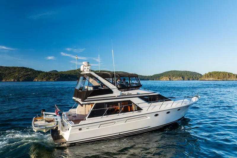 Slide: The Image of 1990 Ocean Alexander 48 Sedan yacht cruising on scenic blue waters. - 12