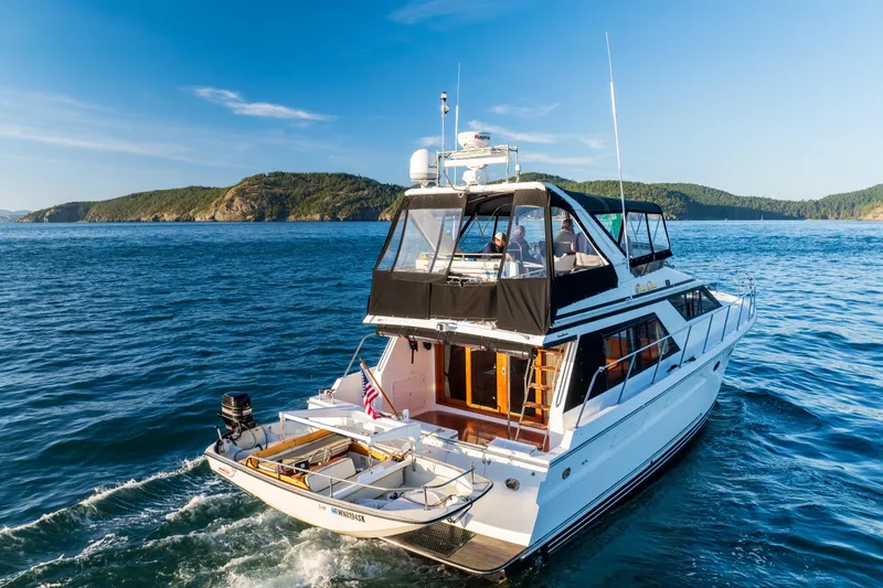 Slide: The Image of 1990 Ocean Alexander 48 Sedan yacht cruising on scenic blue waters. - 15