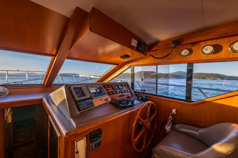 Slide: The Image of Interior helm of 1990 Ocean Alexander 48 Sedan yacht with scenic ocean view. - 16