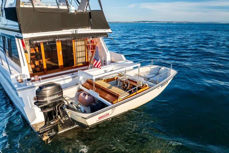 Slide: The Image of Ocean Alexander 48 Sedan yacht, 1990 model, cruising on open water with American flag. - 17