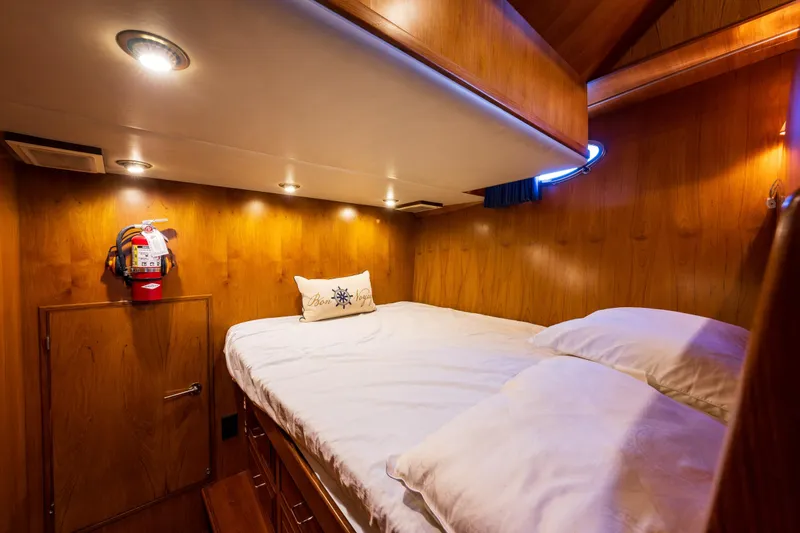 Slide: The Image of Cozy cabin interior of 1990 Ocean Alexander 48 Sedan yacht with wooden paneling and soft lighting. - 19