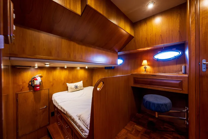 Slide: The Image of Luxurious 1990 Ocean Alexander 48 Sedan cabin with wood paneling and cozy bed. - 20