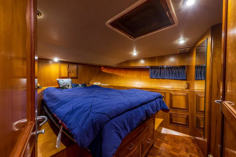 Slide: The Image of Luxurious cabin interior of 1990 Ocean Alexander 48 Sedan yacht with wood paneling. - 24