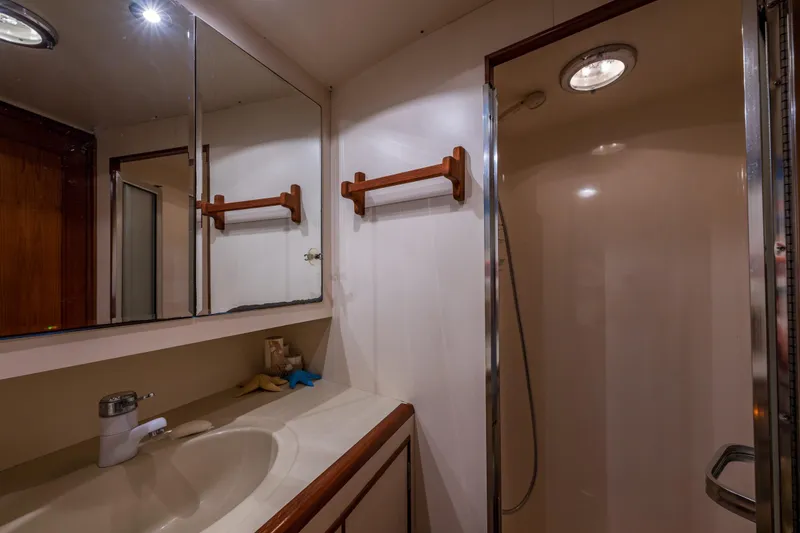Slide: The Image of Bathroom interior of 1990 Ocean Alexander 48 Sedan yacht, featuring sink and shower. - 27