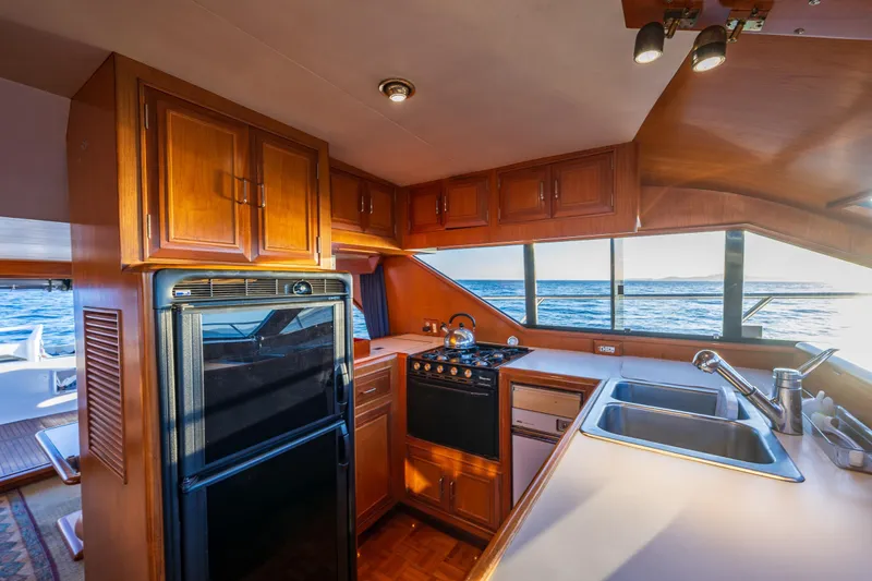 Slide: The Image of Interior of 1990 Ocean Alexander 48 Sedan yacht kitchen with ocean view. - 28
