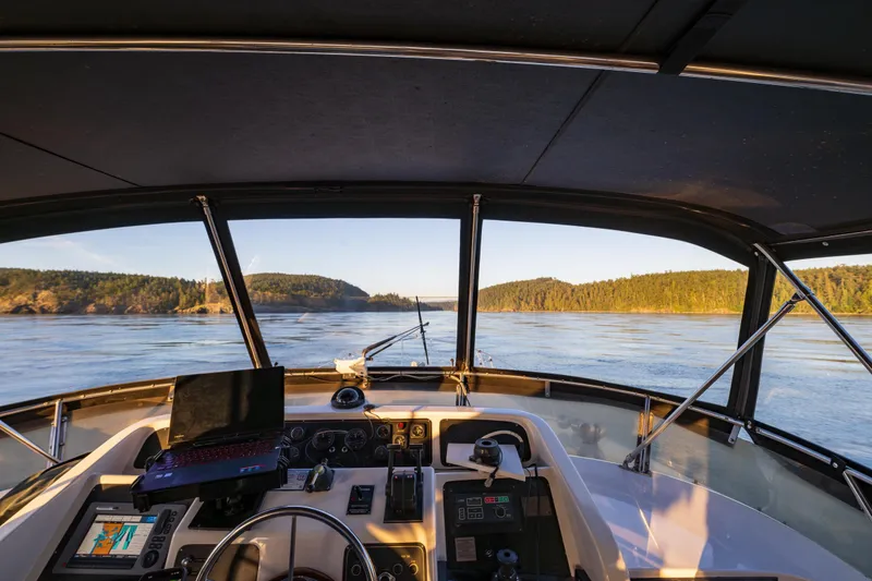 Slide: The Image of Cockpit view from a 1990 Ocean Alexander 48 Sedan, navigating scenic waters. - 32