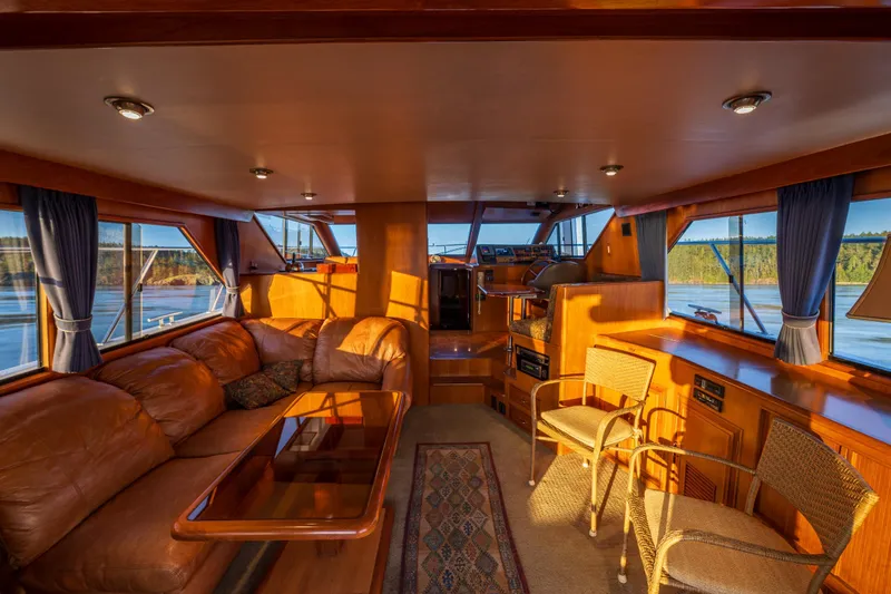 Slide: The Image of Luxurious interior of a 1990 Ocean Alexander 48 Sedan yacht with leather seating and panoramic windows. - 33
