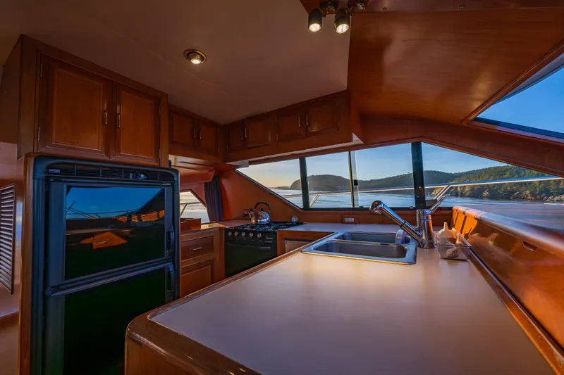 Slide: The Image of Interior of 1990 Ocean Alexander 48 Sedan yacht kitchen with scenic ocean view. - 35
