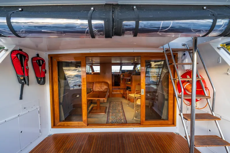 Slide: The Image of 1990 Ocean Alexander 48 Sedan yacht interior with wooden accents and safety equipment. - 38