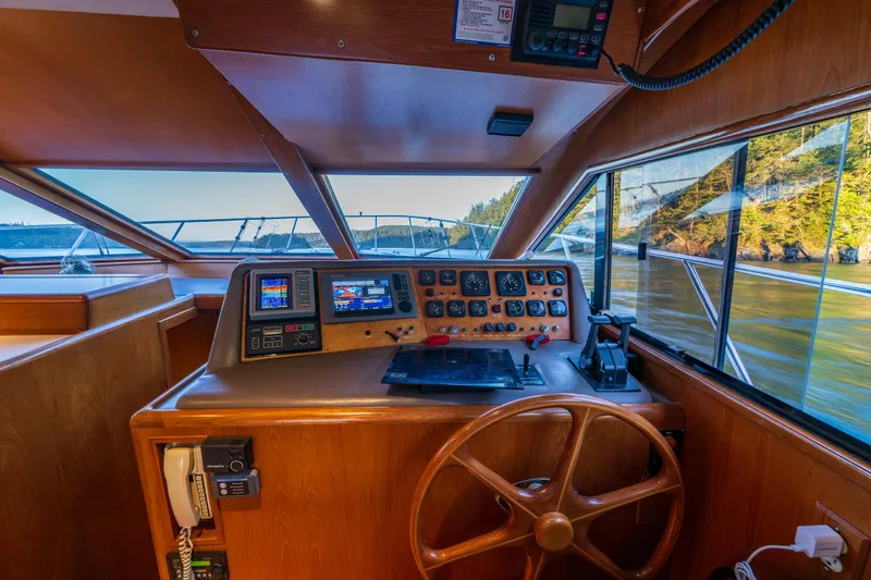 Slide: The Image of Cockpit of 1990 Ocean Alexander 48 Sedan with navigational instruments and wooden steering wheel. - 41