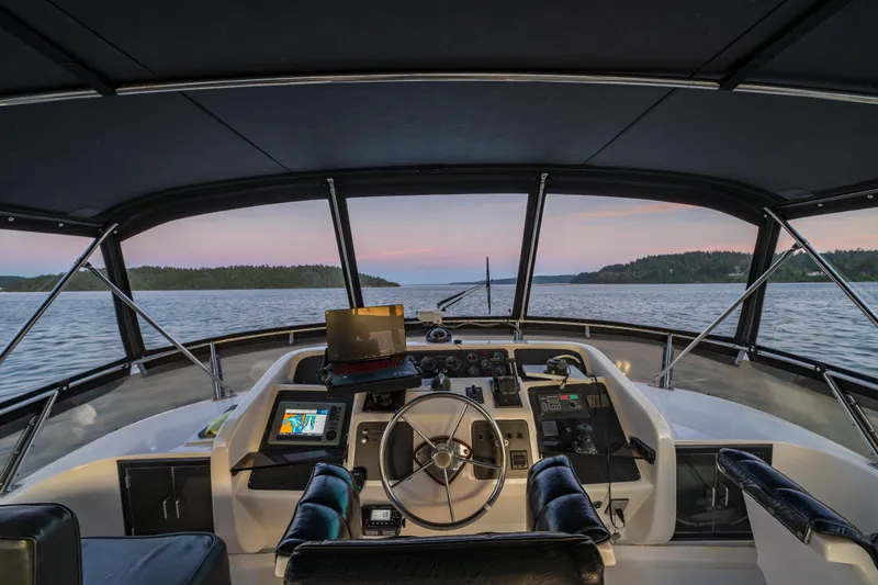 Slide: The Image of Cockpit view of 1990 Ocean Alexander 48 Sedan yacht at sunset on calm waters. - 45
