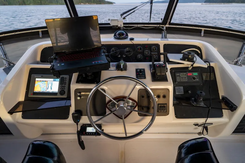 Slide: The Image of Cockpit of 1990 Ocean Alexander 48 Sedan with navigation equipment and steering wheel. - 49