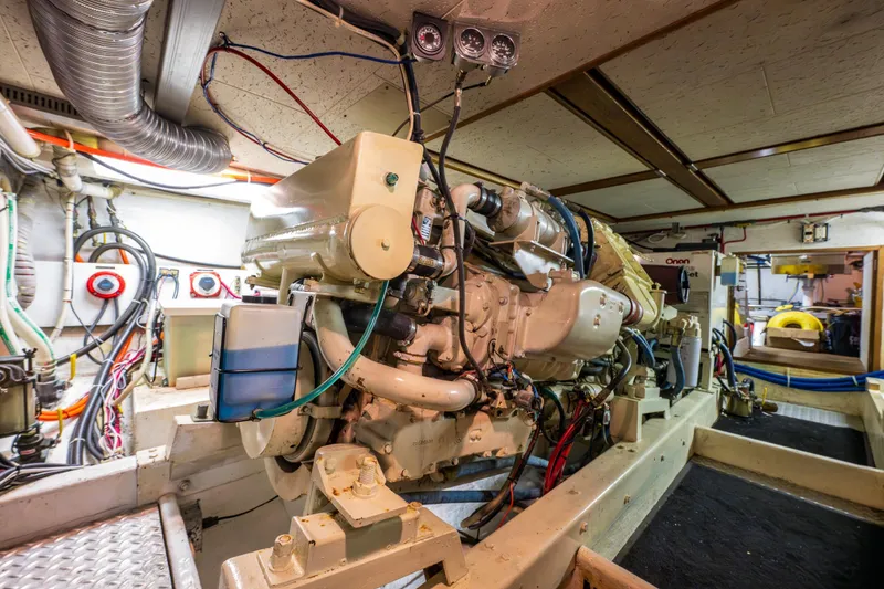 Slide: The Image of Engine room of a 1990 Ocean Alexander 48 Sedan yacht, showcasing machinery and wiring. - 51