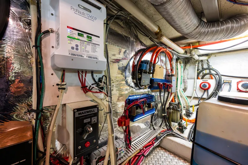Slide: The Image of Engine room of a 1990 Ocean Alexander 48 Sedan, showcasing electrical systems and wiring. - 52