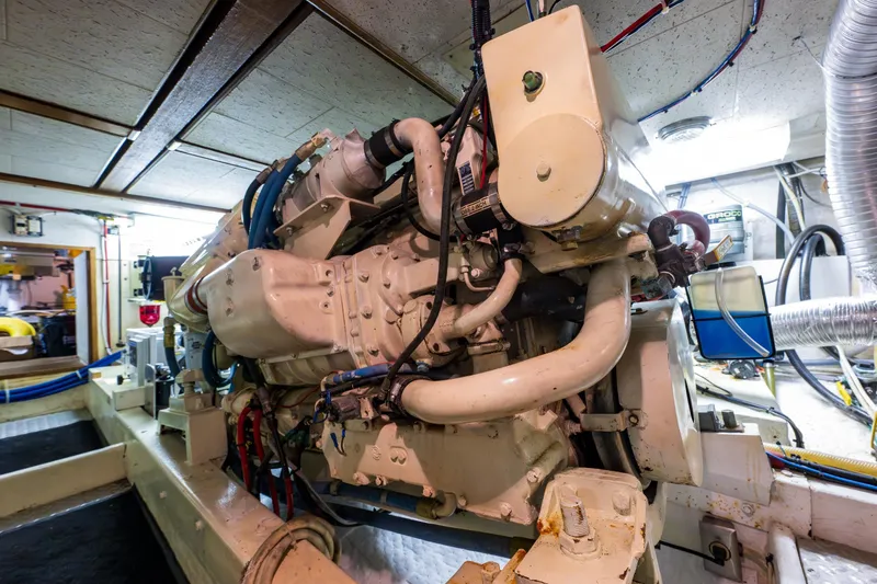 Slide: The Image of Engine room of a 1990 Ocean Alexander 48 Sedan yacht, showcasing machinery and components. - 54