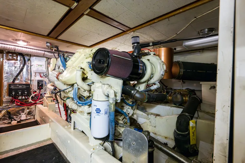Slide: The Image of Engine room of 1990 Ocean Alexander 48 Sedan yacht, showcasing mechanical components and wiring. - 55