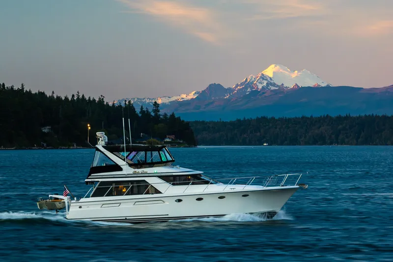 Slide: The Image of Ocean Alexander 48 Sedan yacht cruising with mountain backdrop, 1990 model. - 56