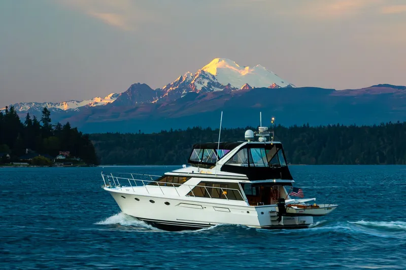 Slide: The Image of Ocean Alexander 48 Sedan yacht cruising with scenic mountain backdrop, 1990 model. - 57