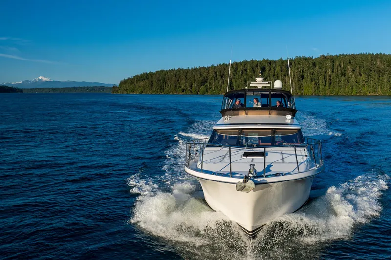 Slide: The Image of Ocean Alexander 48 Sedan yacht cruising on a scenic blue lake, 1990 model. - 8