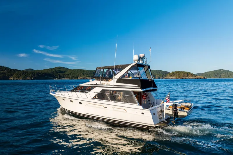 Slide: The Image of 1990 Ocean Alexander 48 Sedan cruising on blue waters under clear skies. - 9