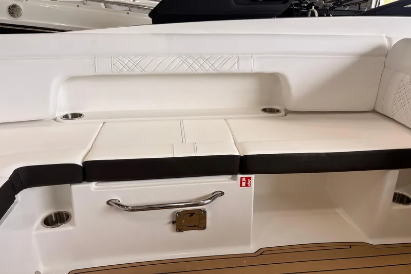 Slide: The Image of Interior seating of 2026 Searay 290 SDX boat with white upholstery and cup holders. - 11