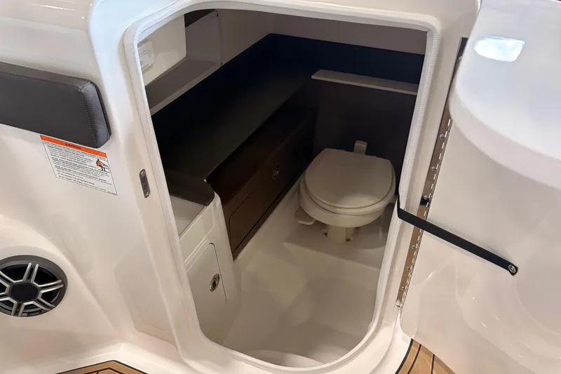 Slide: The Image of 2026 Searay 290 SDX boat interior with compact bathroom and toilet. - 14