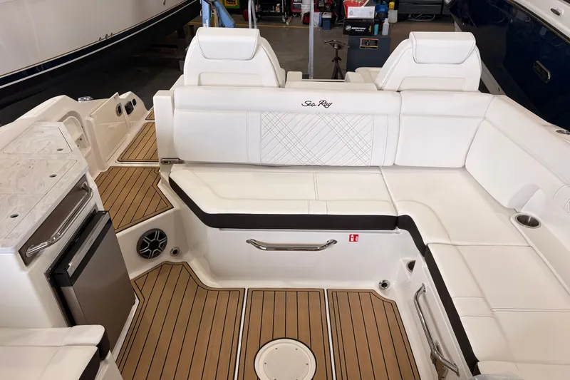 Slide: The Image of 2026 Searay 290 SDX boat interior with white seating and teak flooring. - 17