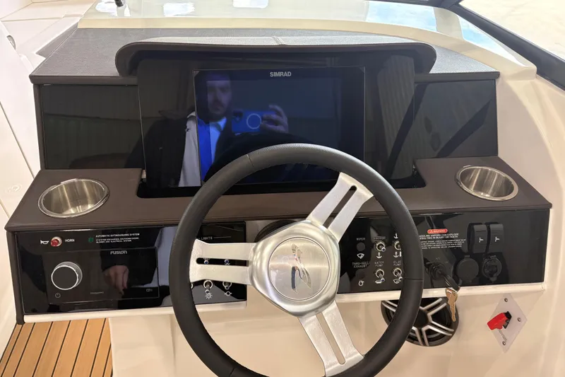 Slide: The Image of 2026 Searay 290 SDX helm with steering wheel, touchscreen, and controls. - 4