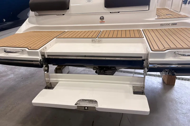 Slide: The Image of 2026 Searay 290 SDX boat with teak swim platform and seating area. - 6