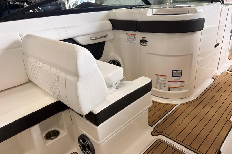 Slide: The Image of 2026 Searay 290 SDX boat interior with white seating and wood-style flooring. - 7