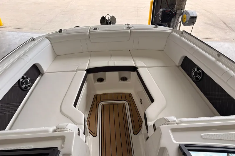 Slide: The Image of 2026 Searay 290 SDX boat interior with white seating and teak flooring. - 8