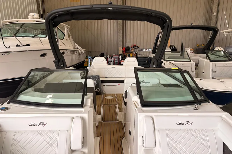 Slide: The Image of 2026 Searay 290 SDX boat interior with sleek design and modern features in a showroom. - 9