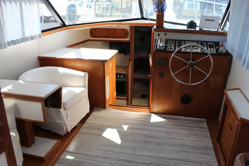 Slide: The Image of Interior of 1990 Carver 3207 Aft Cabin Motor Yacht with helm and seating area. - 10