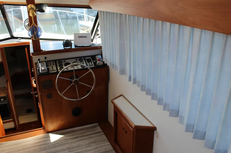 Slide: The Image of Interior helm of 1990 Carver 3207 Aft Cabin Motor Yacht with steering wheel and controls. - 11