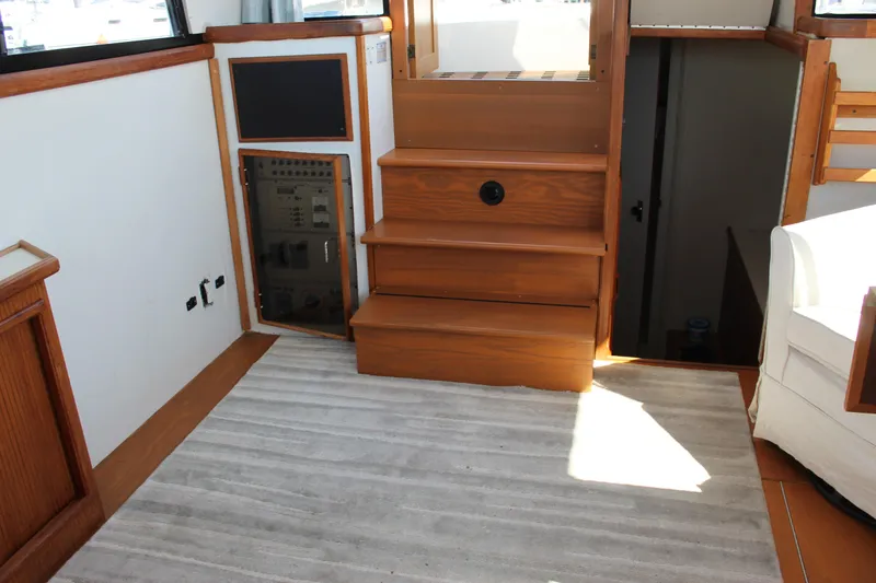 Slide: The Image of Interior of 1990 Carver 3207 Aft Cabin Motor Yacht with wooden stairs and carpet. - 12