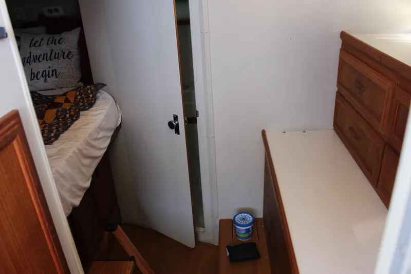 Slide: The Image of Interior of 1990 Carver 3207 Aft Cabin Motor Yacht with bed and wooden drawers. - 16