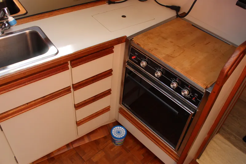 Slide: The Image of 1990 Carver 3207 Aft Cabin Motor Yacht kitchen with stove and sink. - 19